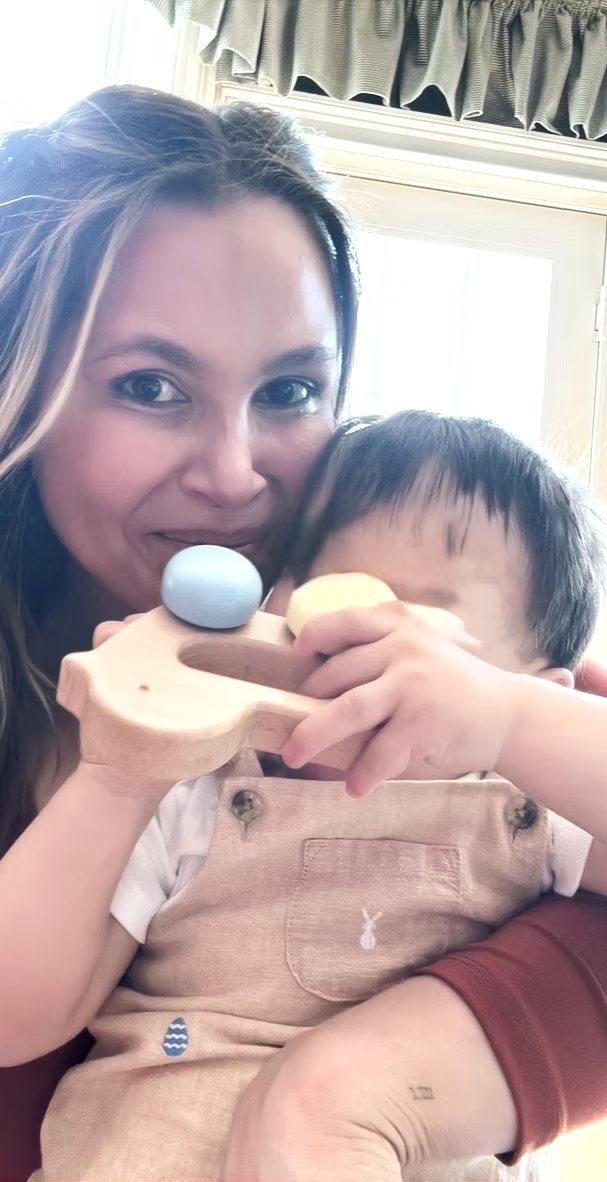 Rachael, founder of Mamentum, holding her son